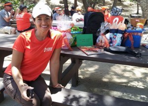 Laura wearing her orange in front of the prizes she collected for the hikers