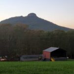 View of Pilot Mountain over farm house